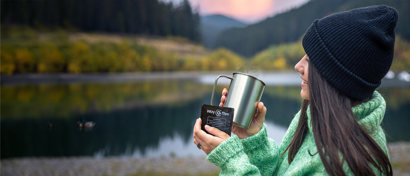 WayCoffee coffee bags in nature hiking with smiling girl who holds the cup